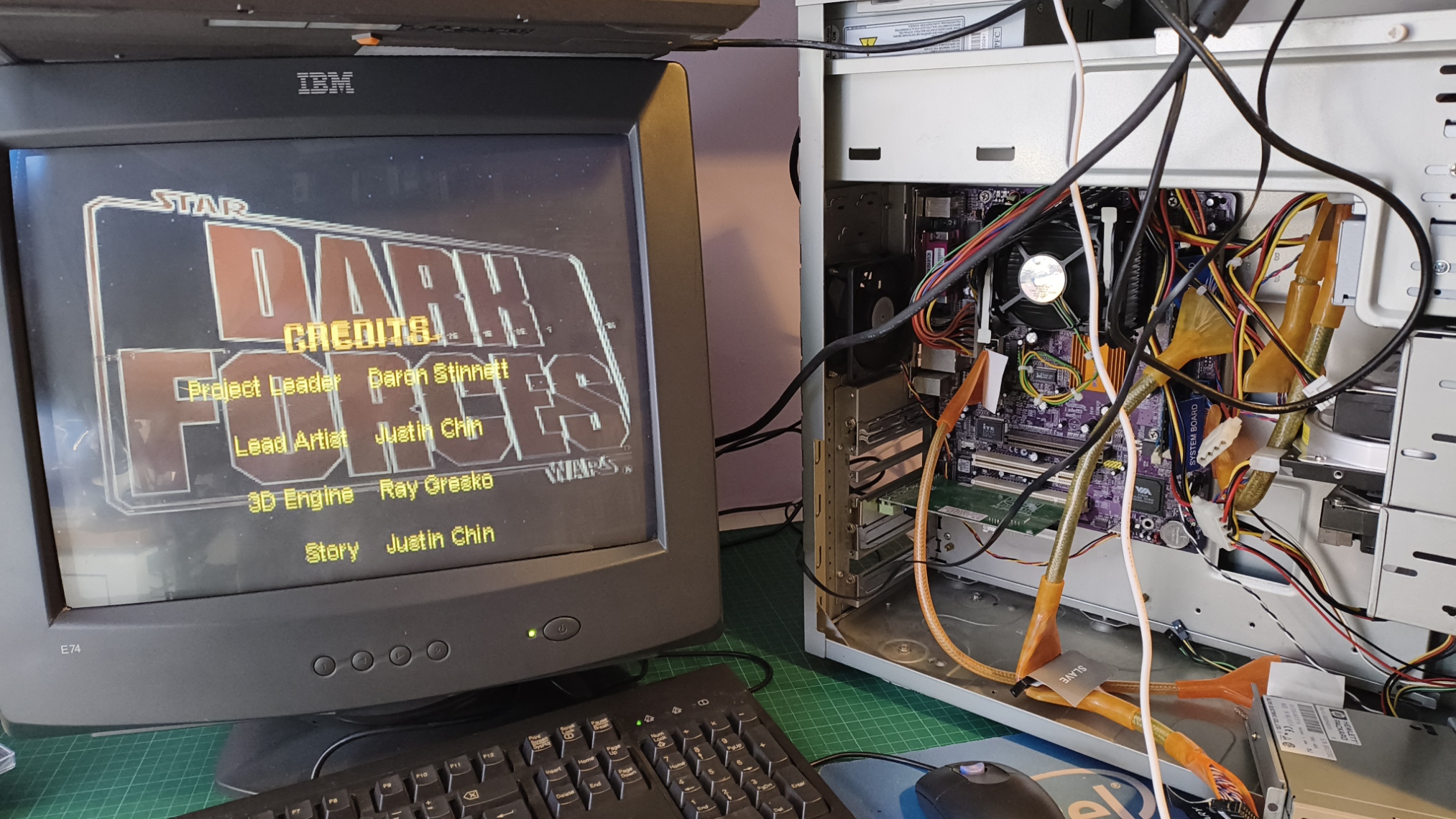 The open test rig beside an IBM monitor running Dark Forces